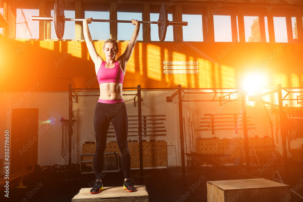 beautiful girl in a gym doing exercises with a barbell Stock Photo ...