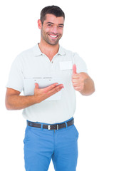 Poster - Smiling male handyman with clipboard gesturing thumbs up