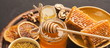 Various types of honey on wooden platter, closeup