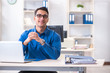 © Elnur - Handsome businessman employee sitting at his desk in office