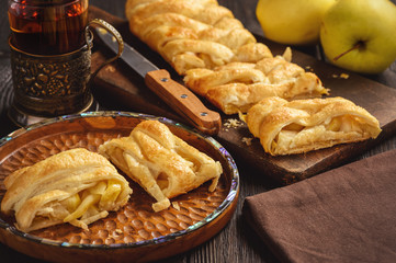 Wall Mural - Apple puff pastry braid, on dark background.