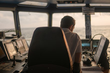 Deck Navigation Officer On The Navigation Bridge. He Looks At Radar Screen. Watchkeeping, Collision Prevention At Sea. COLREG