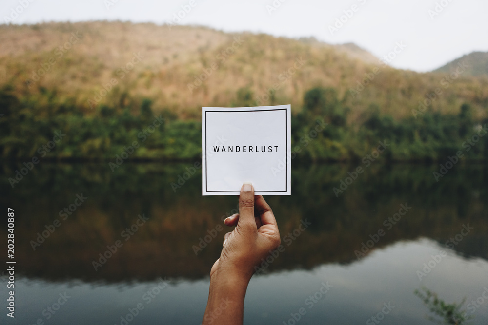 Hand with note, lake with hill in background - obrazy, fototapety, plakaty 