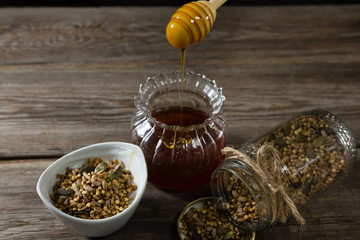 Wall Mural - Breakfast cereals and jar of honey on wooden table