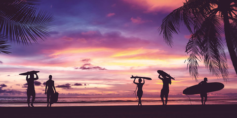 Silhouette of surfer people carrying surfboard