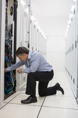 Aufkleber - Man kneeling down and fixing wires