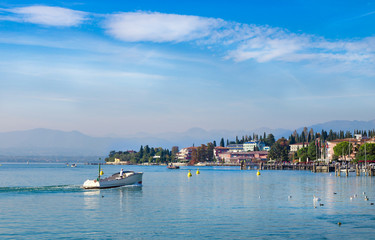 Powerboat sails in Garda lake, Italy.