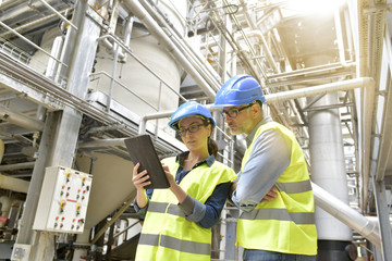 Industrial engineers working in recycling plant with tablet