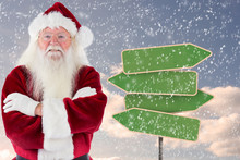 Santa Smiles With Folded Arms Against Empty Green Road Sign
