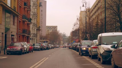 Wall Mural - Warsaw, Poland- December 26, 2017 Parked cars along the road in the old town.