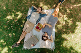 Fototapeta  - Couple relaxing on a picnic at park