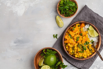 Vegan Sweet Potato Chickpea curry in wooden bowl on a light background, top view. Healthy vegetarian food concept.