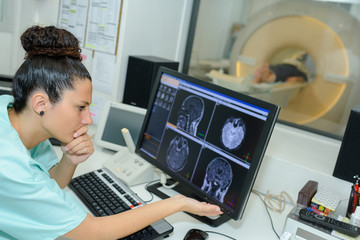 doctor checking mri machine screens