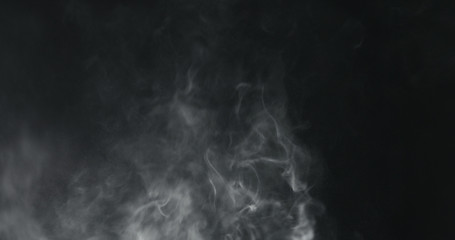 vapor steam rising over black background