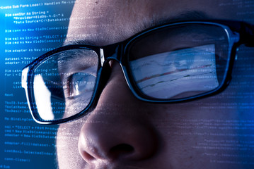 the abstract image of the programmer wear a glasses looking at the source code and chart on the comp