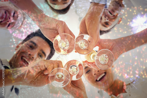 Casual business team toasting with champagne against colourful fireworks explodi Poster