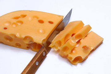 Poster - Knife and a piece of yellow cheese with holes on a white background