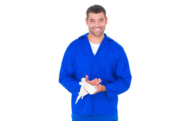 Poster - Smiling mechanic wiping hands with cloth