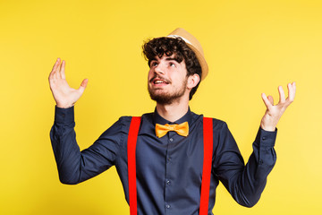 Wall Mural - Studio portrait of a young man on a yellow background.