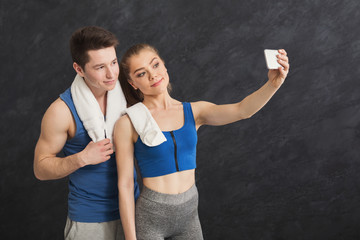 Wall Mural - Young couple making selfie at gym