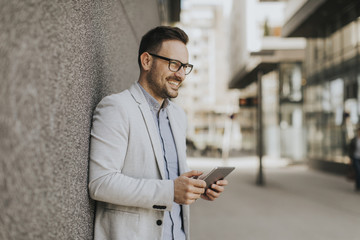 Portrait of a young businessman holding digital tablet