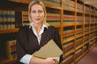 © WavebreakmediaMicro - Serious lawyer holding a file while standing