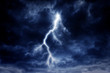 canvas print picture - A lightning strike on a cloudy dramatic stormy sky.