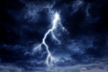 A Lightning Strike On A Cloudy Dramatic Stormy Sky.