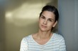 © nyul - Woman leaning against wall portrait