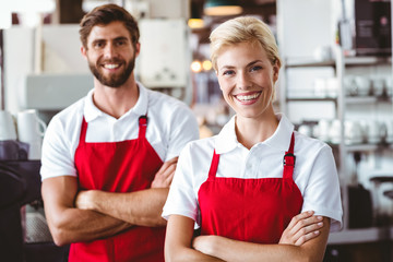 Two baristas smiling at the camera