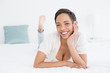 © WavebreakmediaMicro - Smiling pretty young woman relaxing in bed