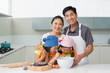 © WavebreakmediaMicro - Family of four preparing cookies in kitchen