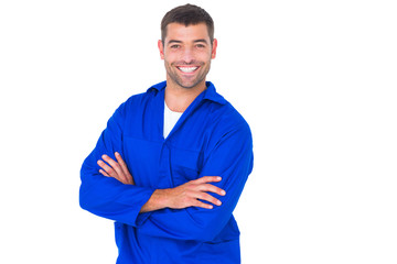 Poster - Mechanic standing arms crossed on white background