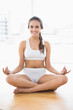 © WavebreakmediaMicro - Cheerful relaxed brunette meditating