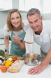 © WavebreakmediaMicro - Couple preparing food together in kitchen