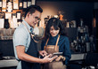 © weedezign - Asia Barista waiter take order from customer in coffee shop,cafe owner writing drink order at counter bar,Food and drink business concept,Service mind concept.restaurant worker