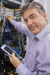 Aufkleber - Man smiling while doing server maintenance with tablet