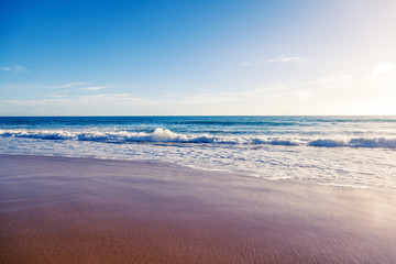 Wall Mural - minimalistic sea background, blue ocean, sandy beach, glare of the sun