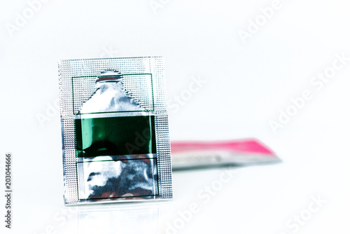 Fotografie, Obraz Mild steroid oral paste in aluminium foil sachet on blur background of sachets