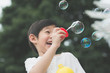 © lalalululala - asian child is blowing a soap bubbles