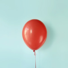 Red air flying ball on light blue background. Event or celebration concept.