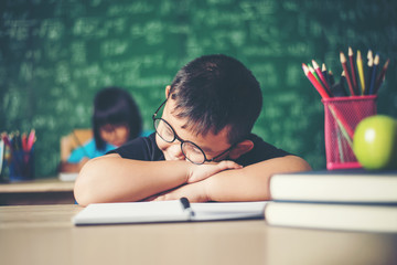 Wall Mural - Boy sleeping on the books in the classroom.