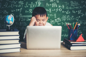 Wall Mural - kid  use computer laptop  in the classroom.