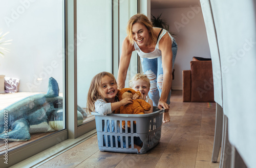 Fotografie, Obraz Mother playing with her children at home
