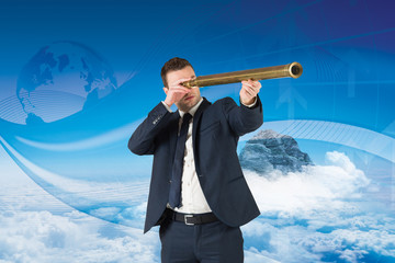 Wall Mural - Businessman looking through telescope against global business graphic in blue