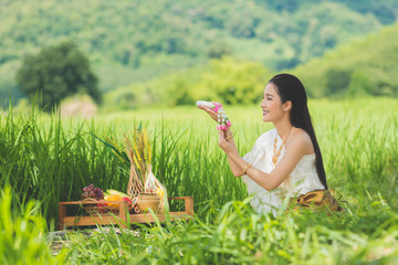 Wall Mural - Beautiful Thai girl in Thai costume,Asian woman wearing traditional Thai culture at farmland;Thailand.