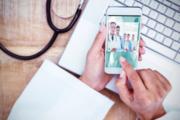 Sticker - View of video chat app against doctor using smartphone on wooden desk 