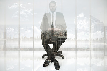 Wall Mural - Stern businessman sitting on an office chair  against new york