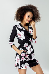 Wall Mural - Beautiful african american young female model wear dress in flowers and smiling