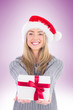 © vectorfusionart - Festive blonde holding christmas gift on vignette background